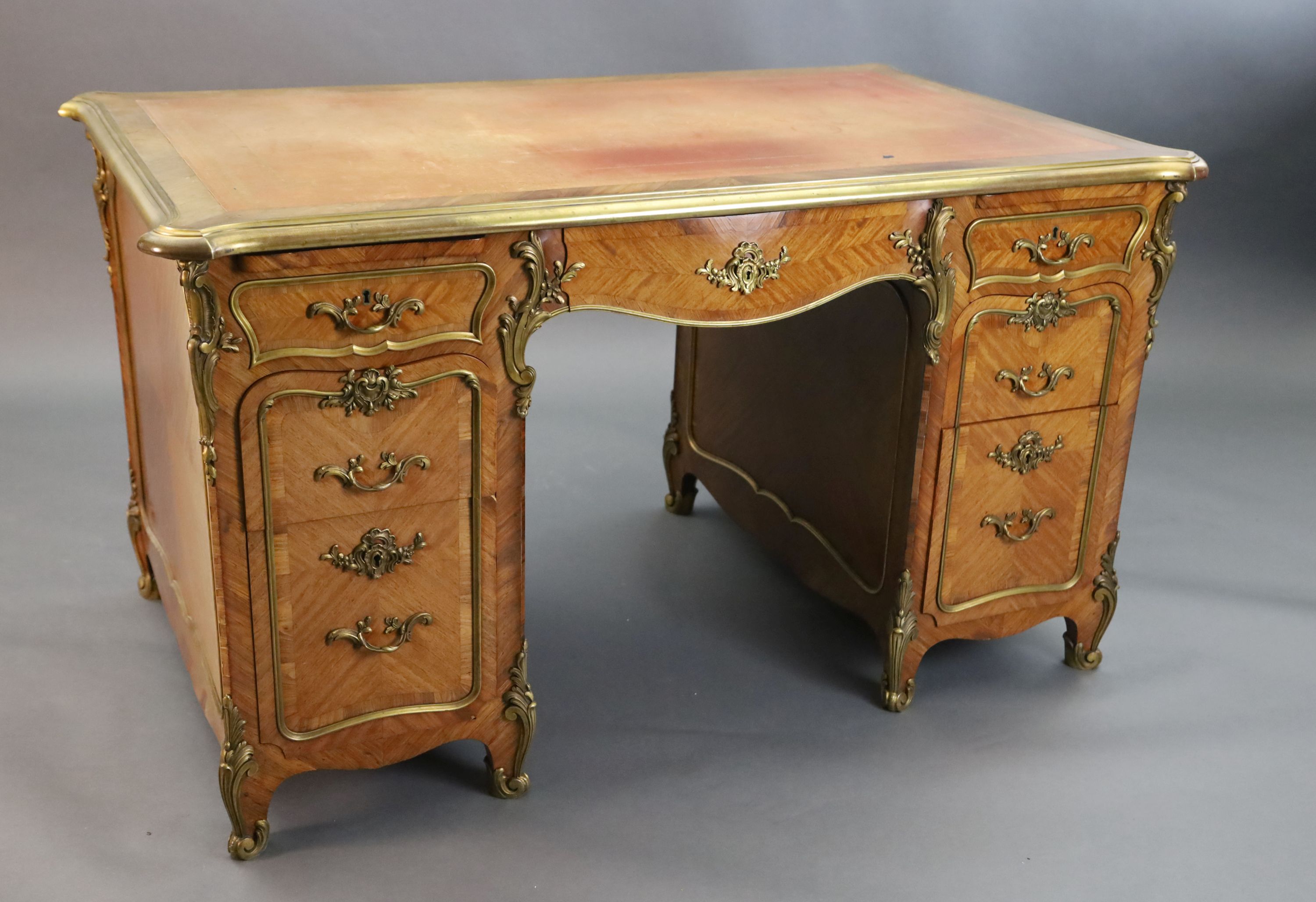 An early 20th century Louis XVI style ormolu mounted satinwood and rosewood kneehole desk, W.4ft 5in. D.2ft 8in. H.2ft 6in.